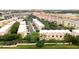 Community aerial showcasing lush green landscaping and manicured lawns alongside buildings with distinct orange roofs at 8024 Cool Breeze Dr # 132, Orlando, FL 32819