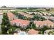 Community aerial view showcasing multiple buildings, a sparkling pool, and lush green landscaping with a city backdrop at 8024 Cool Breeze Dr # 132, Orlando, FL 32819