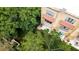 A lush, green aerial view of a residence with a private balcony, surrounded by beautiful trees and landscaping at 8024 Cool Breeze Dr # 132, Orlando, FL 32819