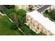 Aerial view of the residence with a private balcony, lush green landscaping, and an inviting outdoor seating area at 8024 Cool Breeze Dr # 132, Orlando, FL 32819