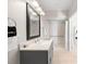 Well-lit bathroom with a gray vanity, modern fixtures, and accessible walk-in shower at 8024 Cool Breeze Dr # 132, Orlando, FL 32819