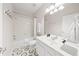 Stylish bathroom with sleek black and white geometric floor tiles, a shower, and ample counter space at 8024 Cool Breeze Dr # 132, Orlando, FL 32819