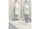 Close up on bathroom sink with chrome fixtures, mirror, and towel hooks at 8024 Cool Breeze Dr # 132, Orlando, FL 32819