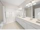 Bright bathroom featuring double sinks, decorative floor tiles, and ample counter space at 8024 Cool Breeze Dr # 132, Orlando, FL 32819