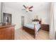 Charming bedroom with wood-look flooring, ceiling fan, and relaxing blue accents, creating a cozy retreat at 8024 Cool Breeze Dr # 132, Orlando, FL 32819