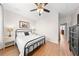 Bright, clean bedroom with hardwood flooring, a ceiling fan, and two bedside tables at 8024 Cool Breeze Dr # 132, Orlando, FL 32819