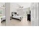 Well-lit bedroom featuring neutral walls, tiled floor, ceiling fan, and a modern black bed and dresser set at 8024 Cool Breeze Dr # 132, Orlando, FL 32819