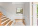 Inviting entryway featuring a staircase, bench, and an artistic painting at 8024 Cool Breeze Dr # 132, Orlando, FL 32819