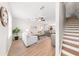 Bright and open living room with hardwood floors, stairs, and modern furnishings at 8024 Cool Breeze Dr # 132, Orlando, FL 32819