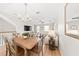 Open-concept living space with wood floors and a stylish chandelier above dining area at 8024 Cool Breeze Dr # 132, Orlando, FL 32819