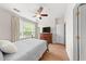 Comfortable main bedroom with a large window, ceiling fan, wood floors and natural light at 8024 Cool Breeze Dr # 132, Orlando, FL 32819