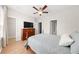 Cozy main bedroom with a ceiling fan, wood floors, and an ensuite bathroom at 8024 Cool Breeze Dr # 132, Orlando, FL 32819