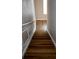Wooden staircase with white railing leading upstairs at 8024 Cool Breeze Dr # 132, Orlando, FL 32819