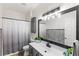 Stylish bathroom features modern vanity, decorative mirror, and shower with modern curtain at 8495 Lake Amhurst Trl, Orlando, FL 32829
