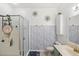 Well-lit bathroom features a walk-in shower, tile flooring, and updated fixtures at 8495 Lake Amhurst Trl, Orlando, FL 32829