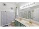 Stylish bathroom featuring double sinks, decorative vanity, shower, and tub at 8495 Lake Amhurst Trl, Orlando, FL 32829
