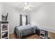 Well-lit bedroom features wood-look floors, ceiling fan, and neutral color palette at 8495 Lake Amhurst Trl, Orlando, FL 32829