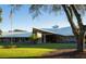 Modern clubhouse with extensive windows, lush landscaping and a meticulously maintained lawn at 8495 Lake Amhurst Trl, Orlando, FL 32829