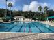 Lap pool with red lane markers, lounge chairs, umbrellas and a building with bathrooms at 8495 Lake Amhurst Trl, Orlando, FL 32829