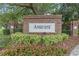 Brick Amhurst community entrance sign surrounded by colorful flowers and greenery at 8495 Lake Amhurst Trl, Orlando, FL 32829