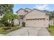 Spacious home with a large two-car garage, a covered front entrance and beautiful landscaping at 8495 Lake Amhurst Trl, Orlando, FL 32829