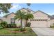 Charming single-story home featuring a well-manicured lawn and attached two-car garage at 8495 Lake Amhurst Trl, Orlando, FL 32829