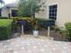 Community grilling area with two grills, lush landscaping and a stone paver surface at 8495 Lake Amhurst Trl, Orlando, FL 32829
