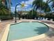 Community kiddie pool featuring a flower water feature, blue tile, lounge chairs, and a brick patio at 8495 Lake Amhurst Trl, Orlando, FL 32829