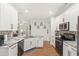 Spacious kitchen features stainless steel appliances, granite countertops, and a view into the living area at 8495 Lake Amhurst Trl, Orlando, FL 32829