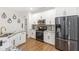 Well-lit kitchen with granite countertops, stainless steel appliances, and white cabinets at 8495 Lake Amhurst Trl, Orlando, FL 32829