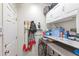 Functional laundry room with modern washer/dryer, storage shelves, and ample counter space at 8495 Lake Amhurst Trl, Orlando, FL 32829