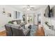 Inviting living room features a sliding glass door, laminate flooring, and comfortable seating at 8495 Lake Amhurst Trl, Orlando, FL 32829
