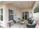 Relaxing covered patio with string lights and comfortable seating area at 8495 Lake Amhurst Trl, Orlando, FL 32829