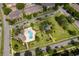 Aerial view of a community pool and clubhouse, set in a park-like green space at 9140 Grey Moss Dr, Orlando, FL 32832