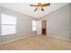 Spacious bedroom with neutral walls, ceiling fan, carpeted floor and two windows at 9140 Grey Moss Dr, Orlando, FL 32832
