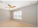 Spacious bedroom with neutral walls, ceiling fan, carpeted floor and a window at 9140 Grey Moss Dr, Orlando, FL 32832