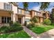 Inviting townhome with brick walkway, lush landscaping, and a charming facade with a covered entry at 9140 Grey Moss Dr, Orlando, FL 32832