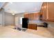 Kitchen with wooden cabinets, black appliances and adjacent casual dining area, ideal for quick meals at 9140 Grey Moss Dr, Orlando, FL 32832