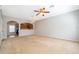 Open concept living room featuring neutral walls and carpet, offering seamless flow into the adjacent kitchen at 9140 Grey Moss Dr, Orlando, FL 32832