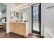 Stylish bathroom with double sinks, modern fixtures, and lots of natural light from the sliding door at 915 Lockbreeze Dr, Davenport, FL 33897