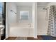 Bright bathroom features a garden tub, separate shower, and large window, offering a spa-like experience at 915 Lockbreeze Dr, Davenport, FL 33897
