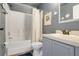 Comfortable bathroom featuring tiled shower/tub combo, neutral paint, and classic fixtures at 915 Lockbreeze Dr, Davenport, FL 33897