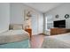 Bright bedroom featuring twin beds, hardwood floors, and a window for a cozy and inviting atmosphere at 915 Lockbreeze Dr, Davenport, FL 33897