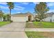 Charming single-Gathering home with well-manicured lawn and mature trees creating curb appeal at 915 Lockbreeze Dr, Davenport, FL 33897