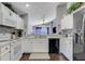 Functional kitchen with white appliances and ample counter space overlooking living area, perfect for cooking at 915 Lockbreeze Dr, Davenport, FL 33897