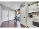 Well-lit eat-in kitchen with modern appliances, hardwood floors, and a cozy breakfast nook with rounded windows at 915 Lockbreeze Dr, Davenport, FL 33897