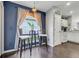 Charming kitchen nook with dark accent wall, barstools, and window overlooking the backyard at 915 Lockbreeze Dr, Davenport, FL 33897