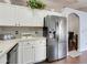 Well-lit kitchen featuring stainless steel appliances and white cabinets for a modern and spacious feel at 915 Lockbreeze Dr, Davenport, FL 33897