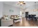 Open-concept living room boasts wood floors, high ceilings, and ample natural light, perfect for entertaining at 915 Lockbreeze Dr, Davenport, FL 33897