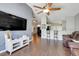 Open living area with bar top and seating overlooking the kitchen and white entertainment center at 915 Lockbreeze Dr, Davenport, FL 33897